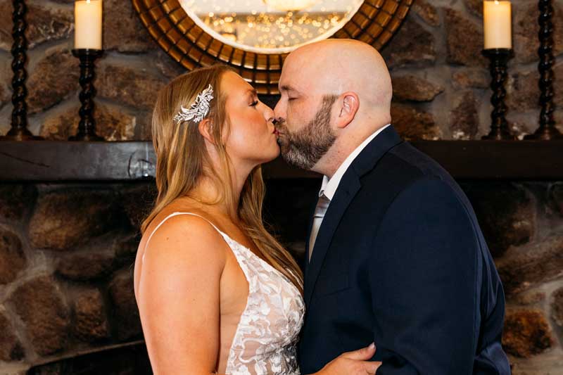 the fox & hound tavern is an intimate wedding reception venue in quincy ma - photo of past couple kissing during a photoshoot during their wedding day here