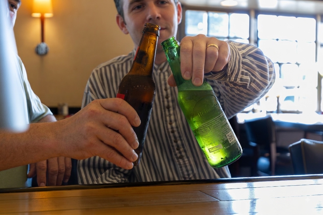 tavern and live events south shore massachusetts - two men clink beer bottles together to make a toast